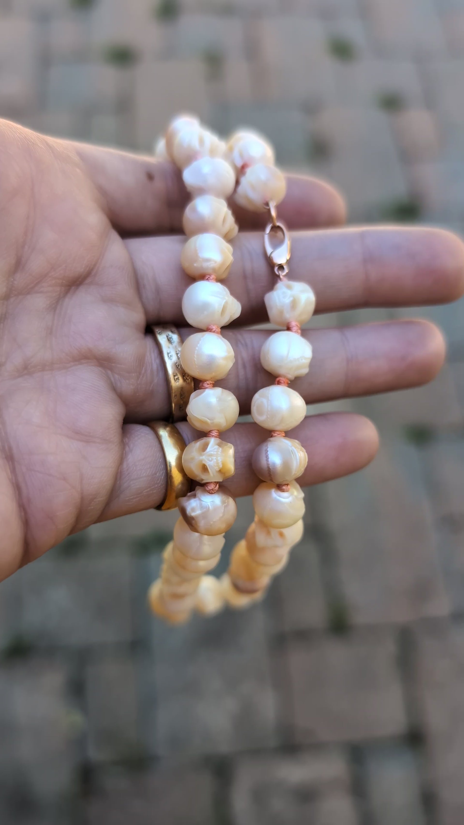 Skull Pearl Necklace held in hand
